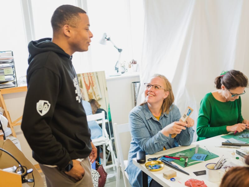 A man and a woman making rings at a jewellery class